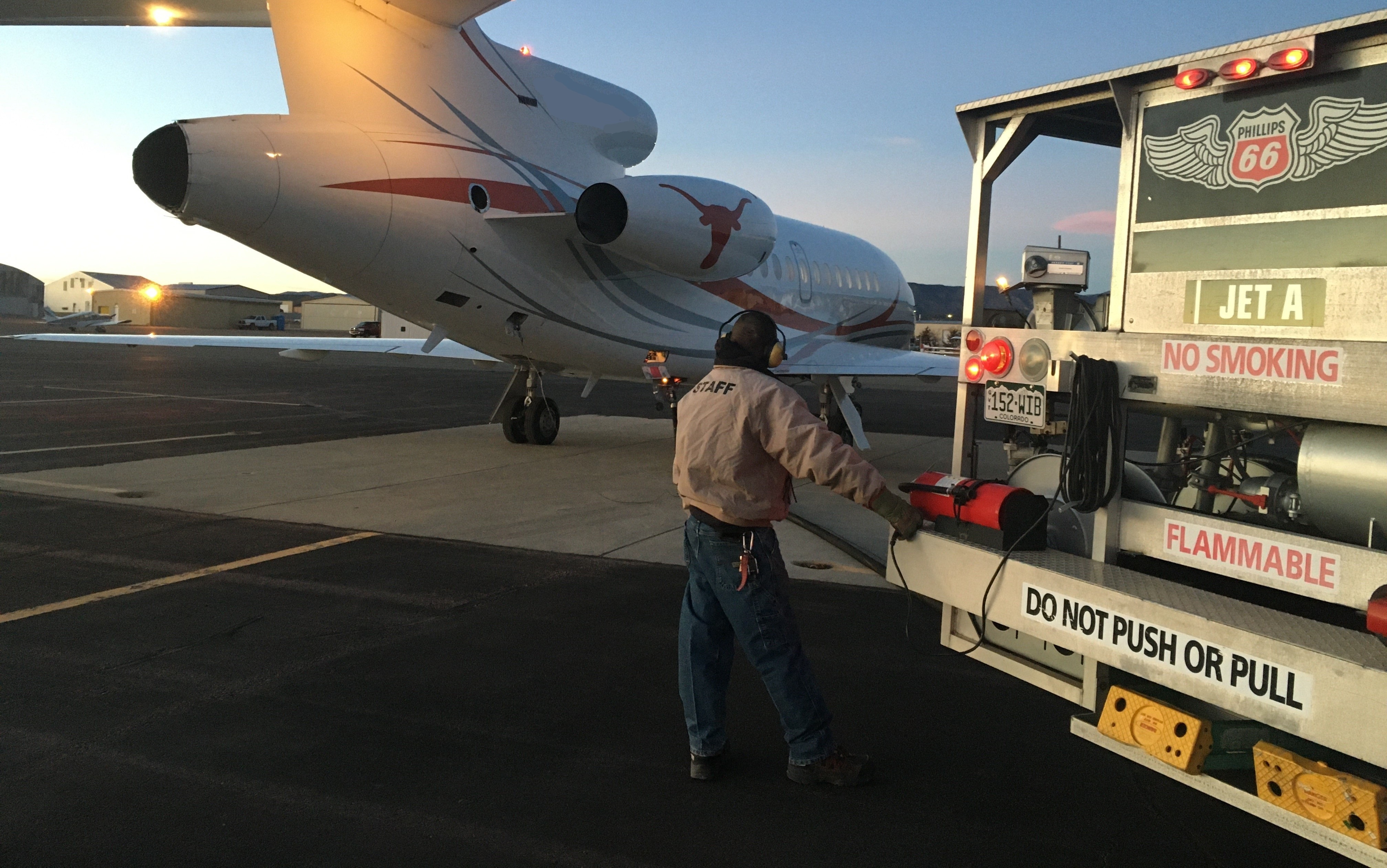 Airport staff providing service to a plane.