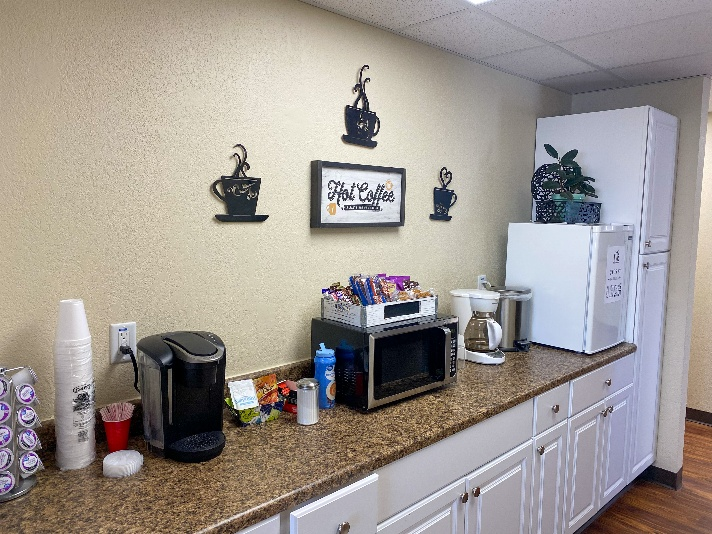 Airport lobby, showing kitchen area with mini-gridge, microwave, and coffee machines.